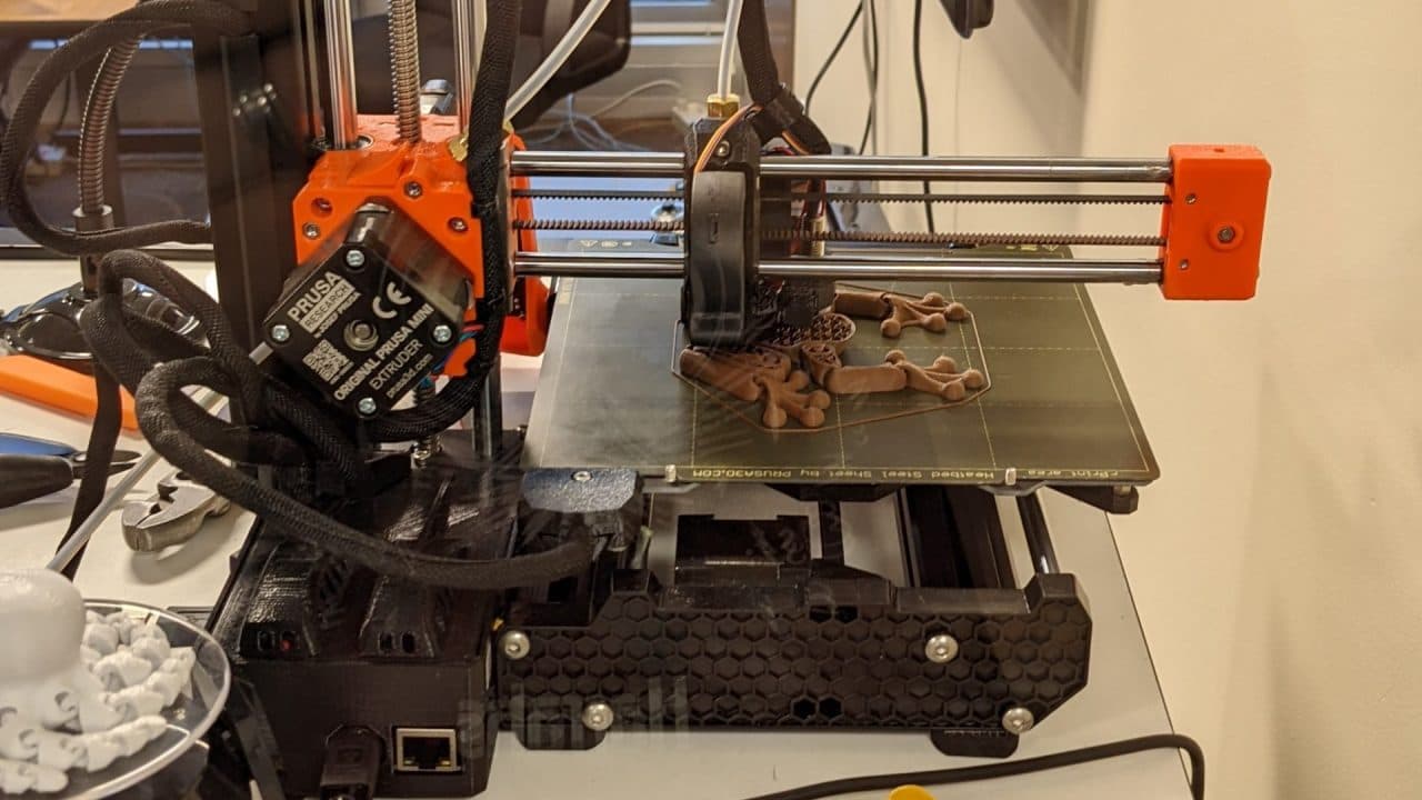 The 3D printer at Owen County Public Library mid-print, with a partial object visible on the print bed.