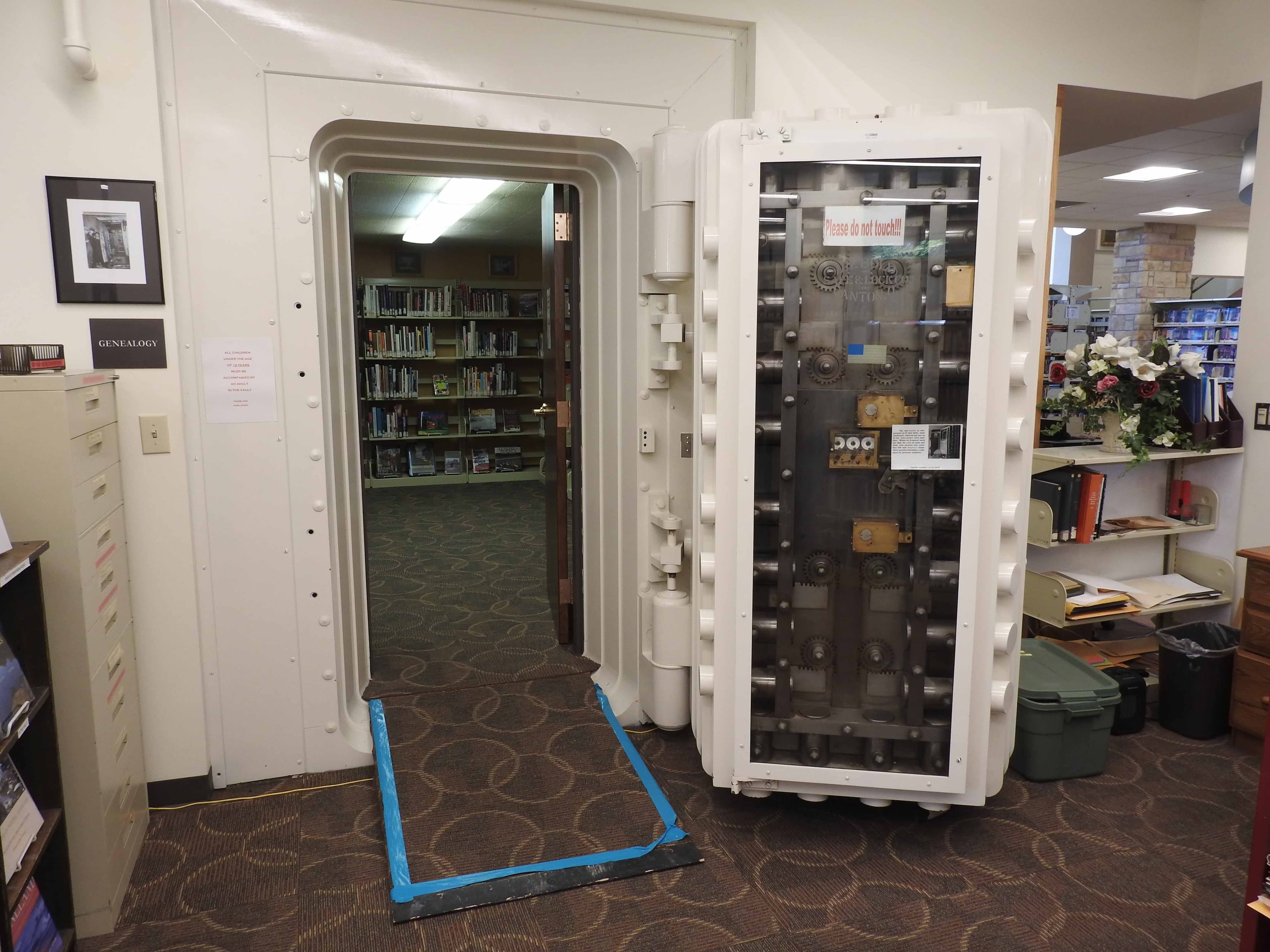 Genealogy room shelves stacked with bound newspaper archives and yearbooks at Owen County Public Library.