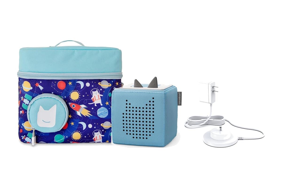 Blue space-print Tonies travel bag, a light blue Toniebox, and a white charging station